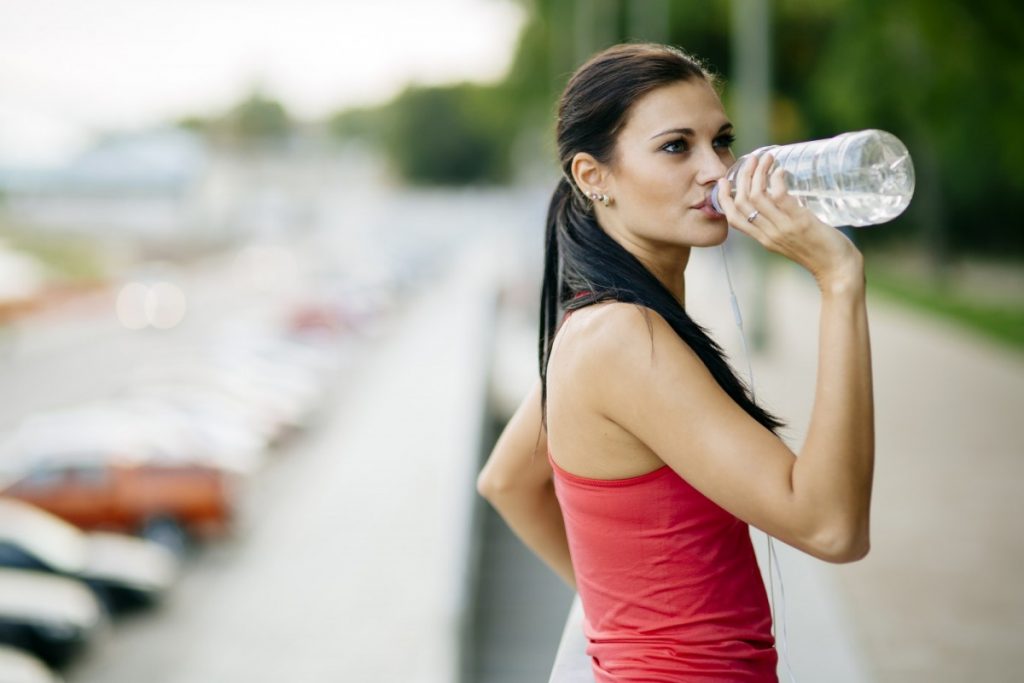 13 Ways To Look 10 Years Younger Naturally Without Costing The Earth; Attractive woman drinking water