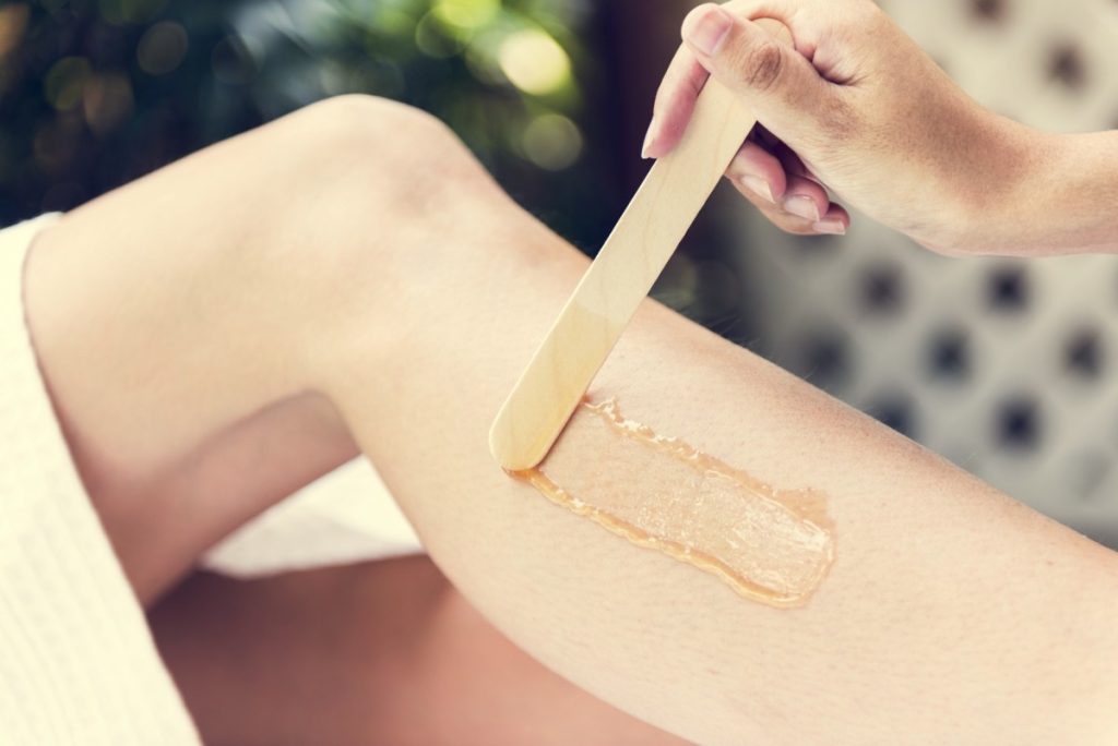 19 Ridiculously Easy Home Spa Treatments; Woman getting legs waxed at a spa