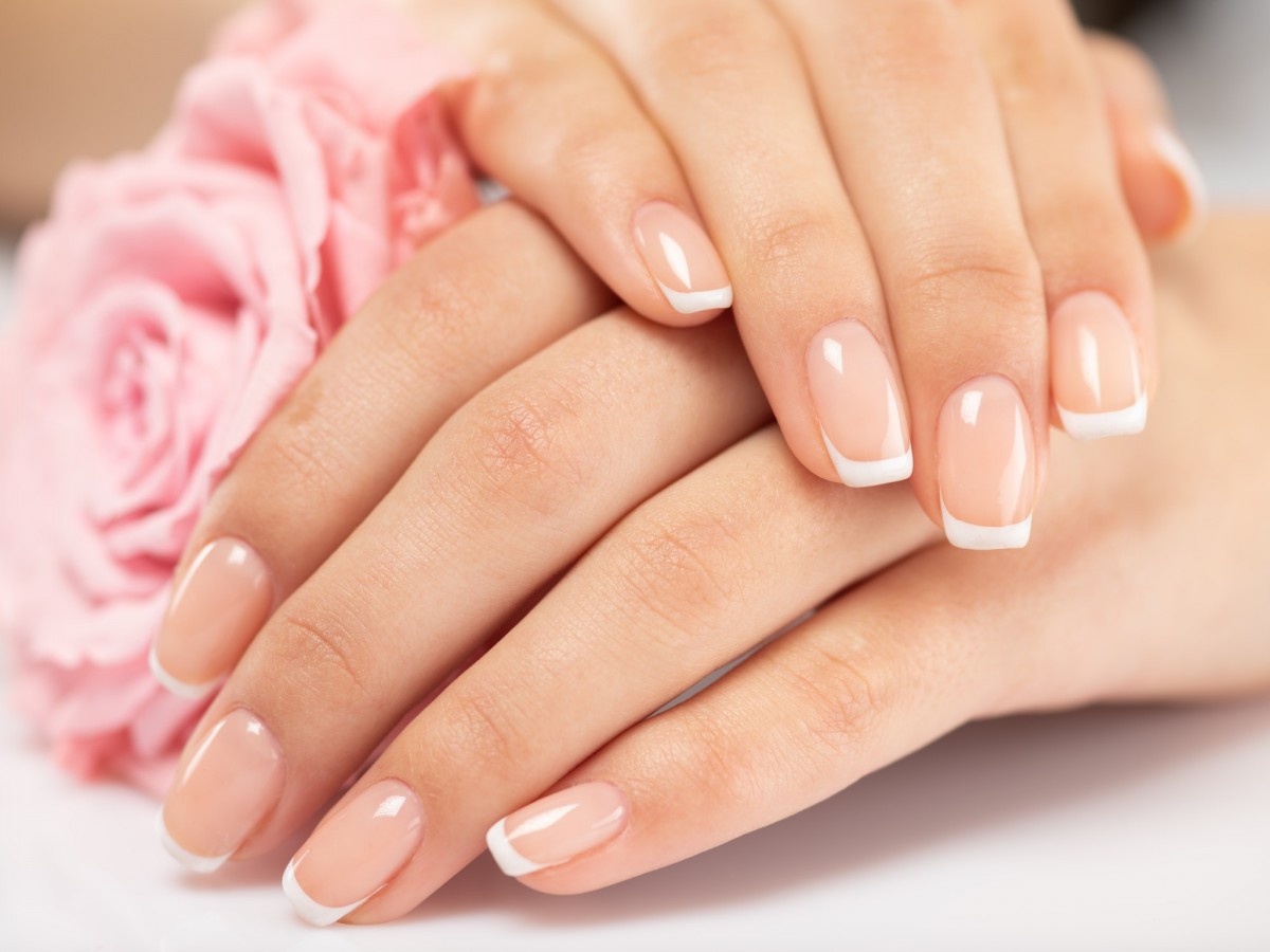 10 Natural Nail Polish Remover Substitutes: Easy & Healthy; Woman gets manicure procedure in a spa salon. Beautiful female h