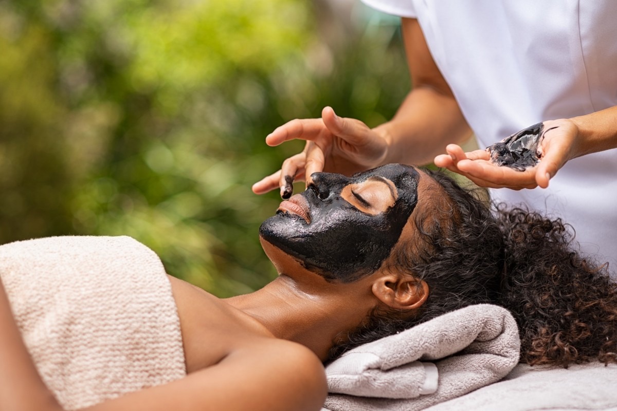 10 Step Korean Skin Care Routine - The Natural Way; Woman getting charcoal facial at beauty resort